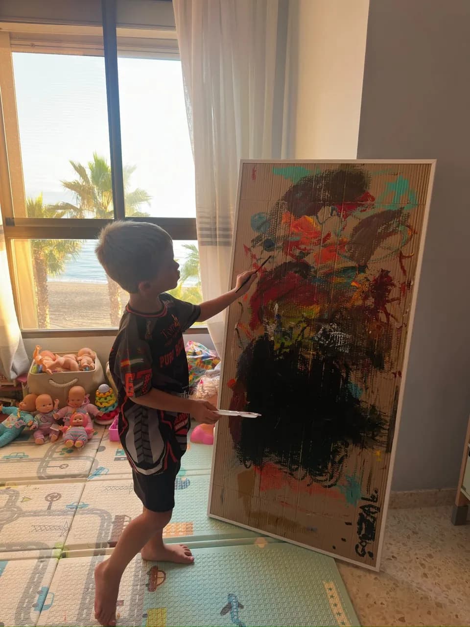 Gonzalo paints the work that The Rodríguez gave him framed for his fifth birthday.